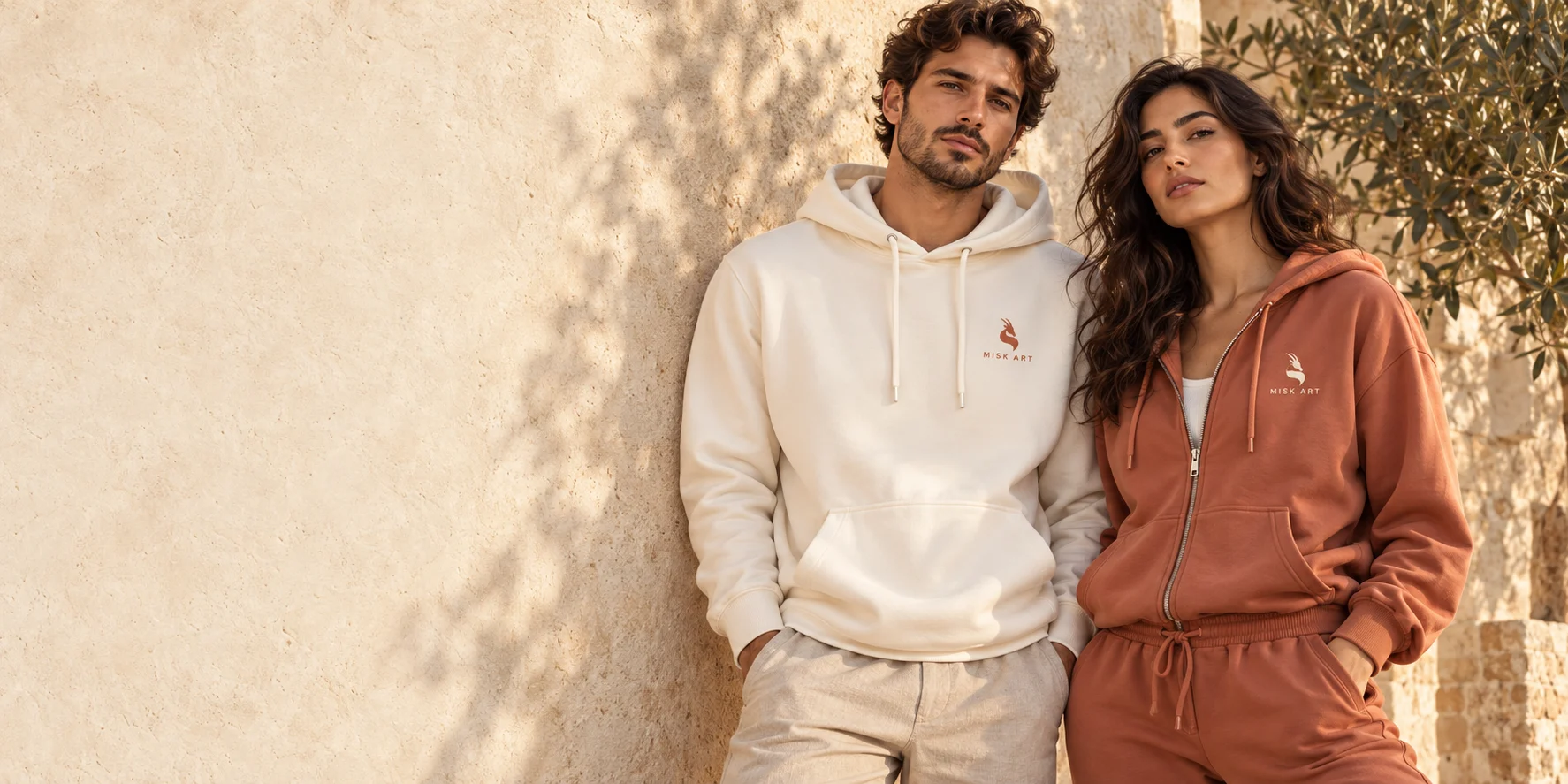 MISK ART ivory and terracotta hoodies with embroidered gazelle emblems
