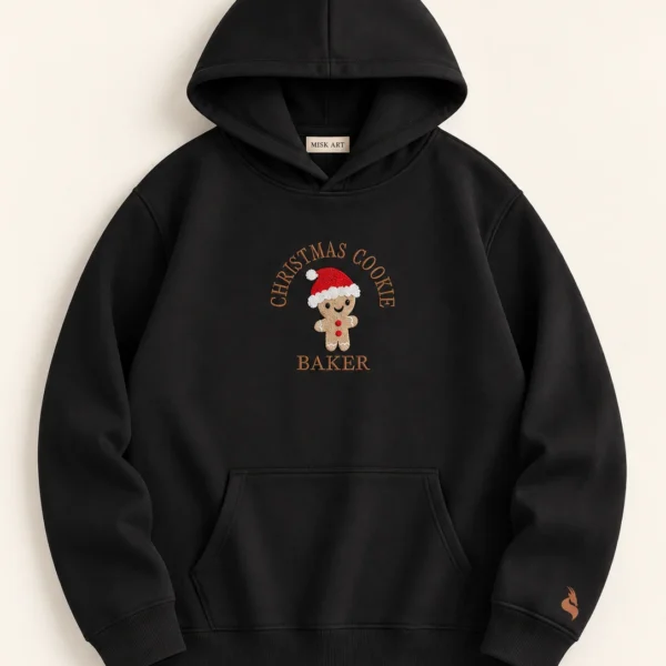 MISK ART Christmas Cookie Baker Hoodie – Black Front, gazelle branding on an ivory studio background