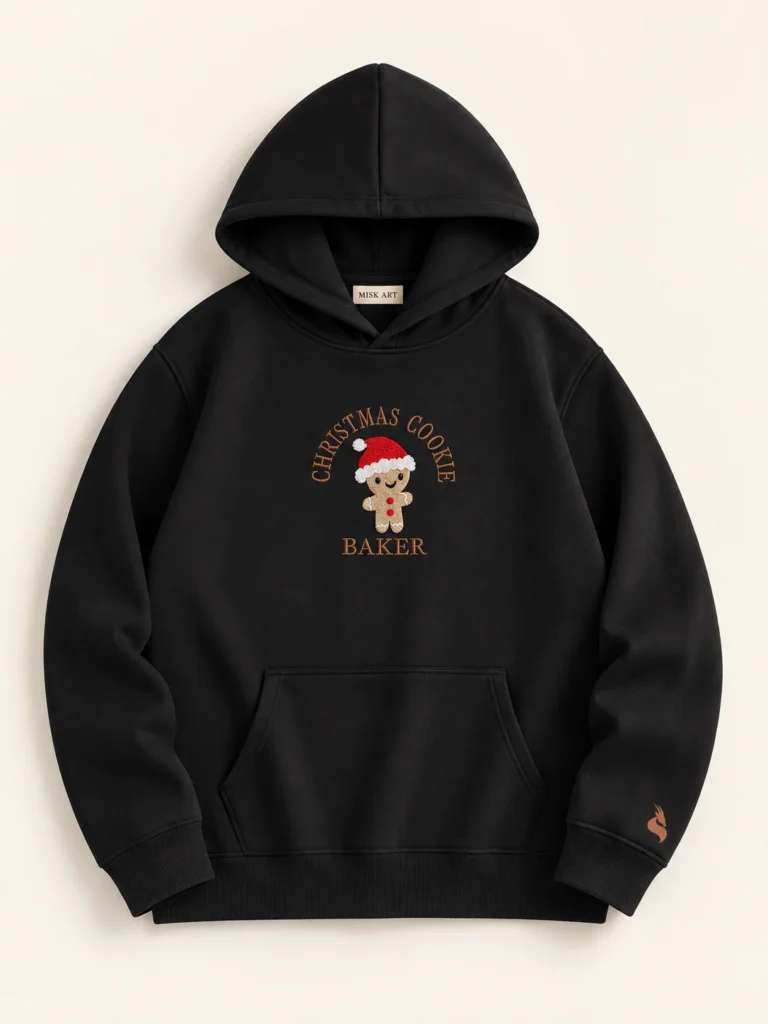 MISK ART Christmas Cookie Baker Hoodie – Black Front, gazelle branding on an ivory studio background