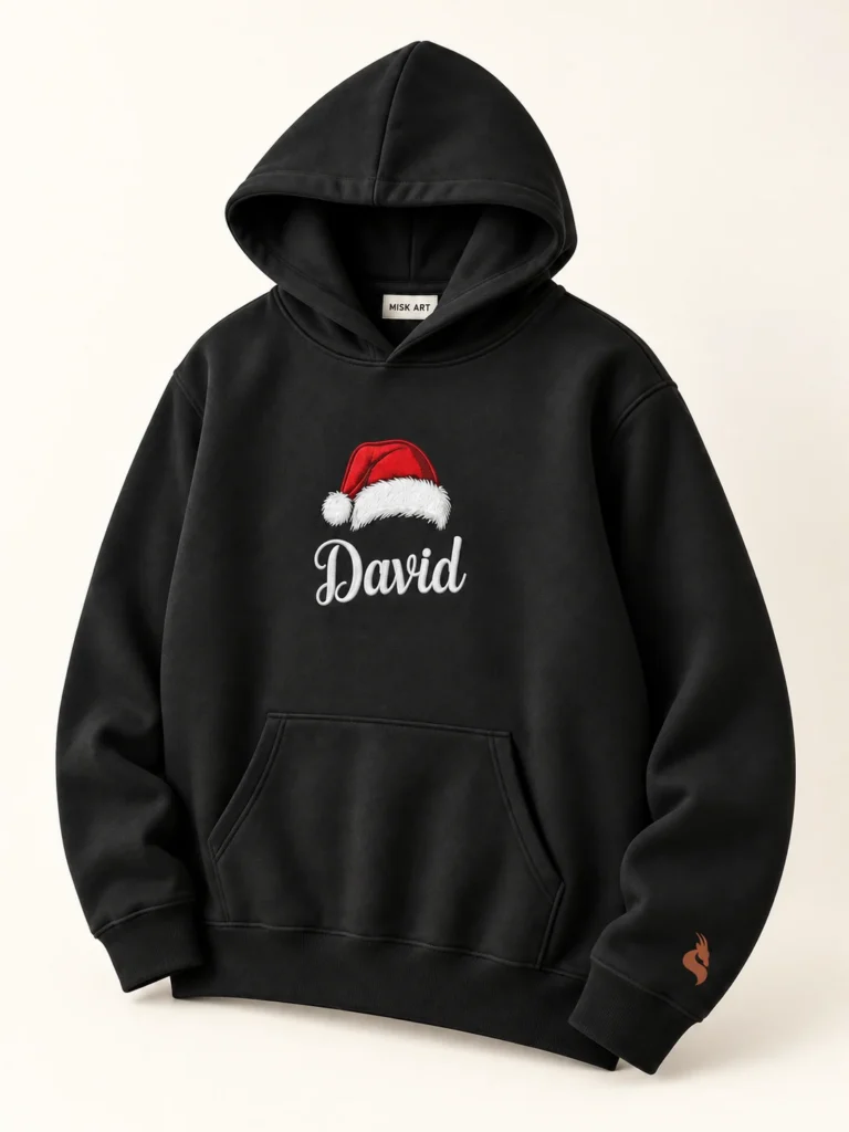 MISK ART Personalized Santa Hat Name Hoodie – Black Detail, gazelle branding on an ivory studio background