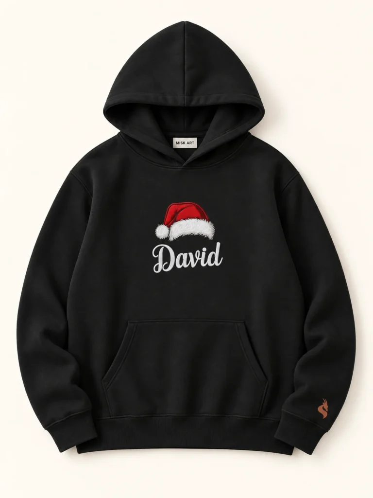 MISK ART Personalized Santa Hat Name Hoodie – Black Front, gazelle branding on an ivory studio background